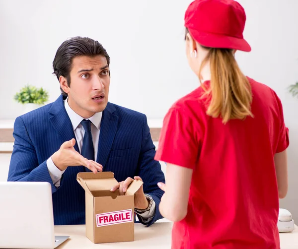 Courier delivering parcel to the office — Stock Photo, Image