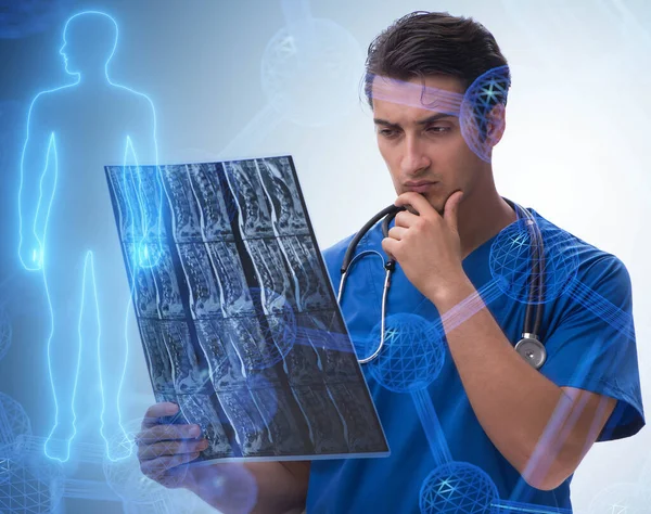 Médico jovem olhando para a imagem de raios-x no conceito mhealth — Fotografia de Stock
