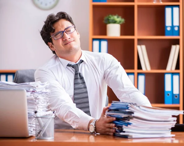 Young handsome businessman unhappy with excessive work — Stock Photo, Image