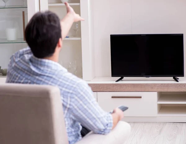 Young man watching tv at home Royalty Free Stock Photos