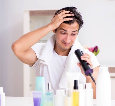 Tuvaletteki genç yakışıklı adam hijyen konseptinde.