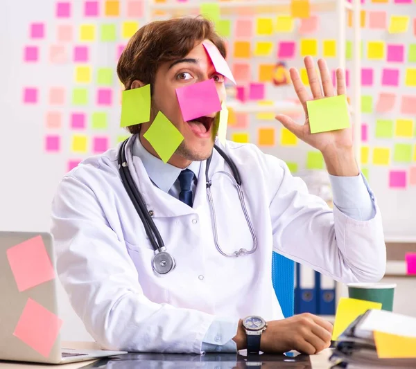 Male doctor with many conflicting prioritites — Stock Photo, Image