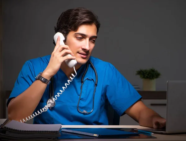 Young handsome doctor working night shift in hospital — Stock Photo, Image