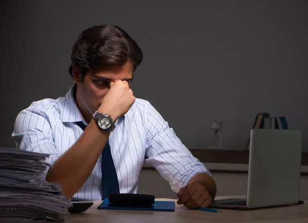 Jovem gerente financeiro trabalhando até tarde da noite no escritório — Fotografia de Stock