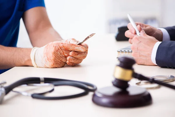 Male doctor in courthouse meeting with advocate