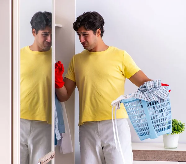 Young handsome man cleaning in the bedroom — Stock Photo, Image