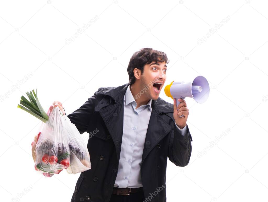 Young handsome man with vegatables in shopping concept