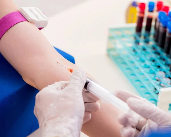 Young patient during blood test sampling procedure