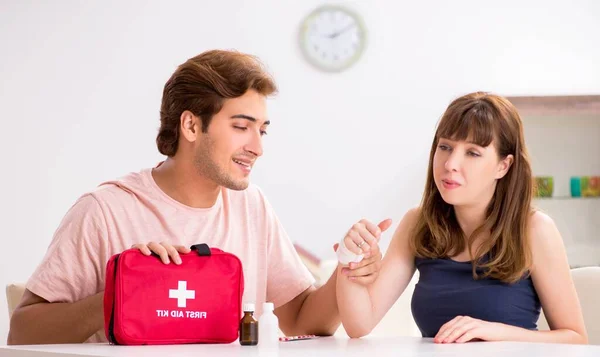 Young family getting treatment with first aid kit — Stock Photo, Image