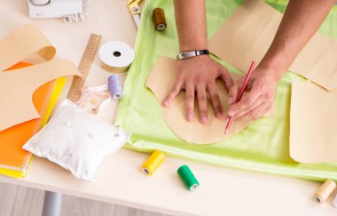 Atölyesinde çalışan yakışıklı bir terzi.