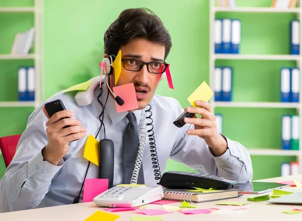 Young help desk operator working in office with many conflicting — Stock Photo, Image