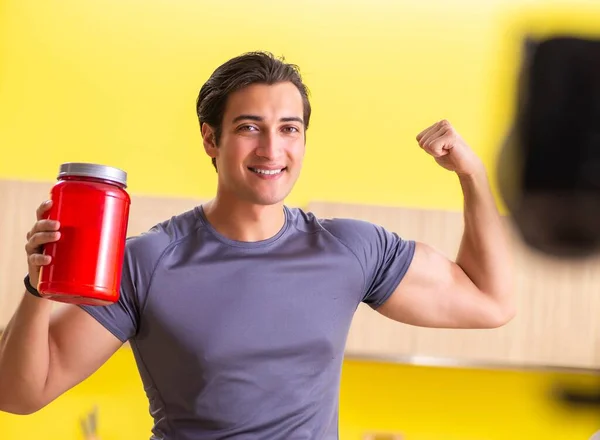 Young man blogging about food supplements — Stock Photo, Image