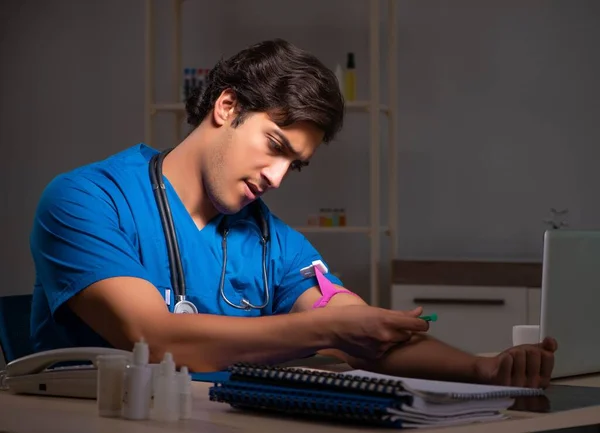 Young handsome doctor working night shift in hospital — Stock Photo, Image