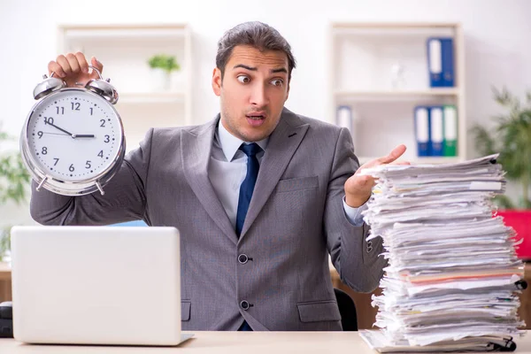 Young male businessman unhappy with excessive work — Stock Photo, Image