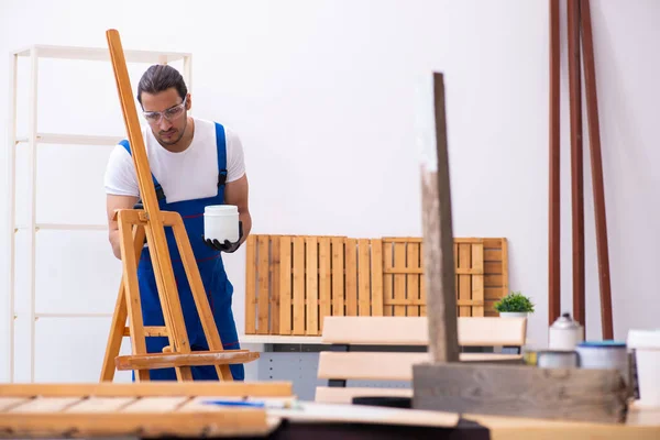 Jonge mannelijke aannemer werkzaam in werkplaats — Stockfoto