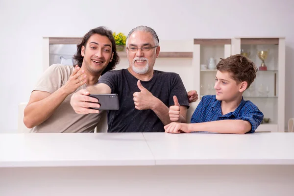 Grandfather learning new technology from son and grandson — Stock Photo, Image