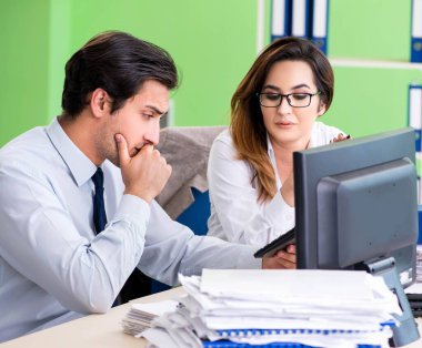 Ofiste çalışan iki finans uzmanı.