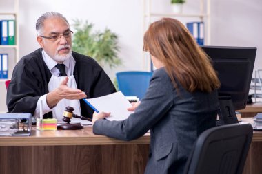 Yaşlı yargıç ve bayan müvekkil büroda.
