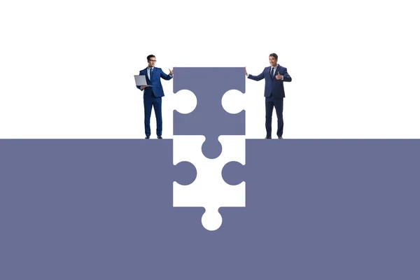 Businessman in teamwork concept with jigsaw puzzle — Stock Photo, Image