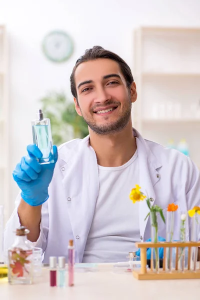Young male chemist in perfume synthesis concept — Stock Photo, Image