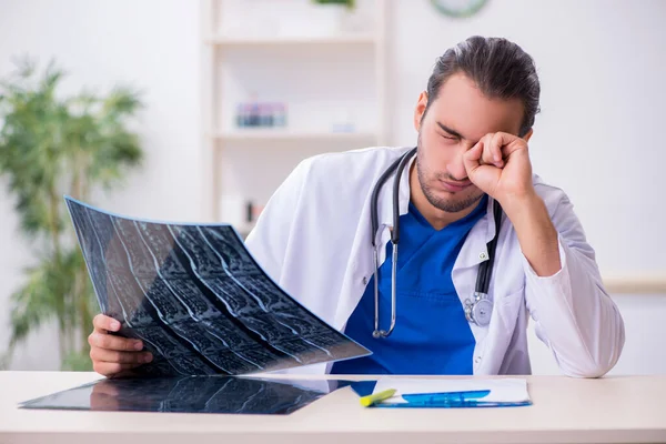 Young male doctor being tired after night shift — Stock Photo, Image