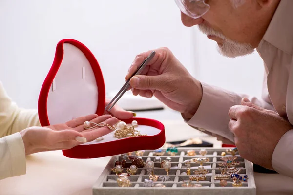 Young woman visiting old male jeweler — Stock Photo, Image