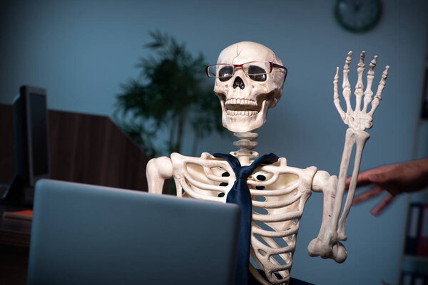 Young male employee working in the office night time