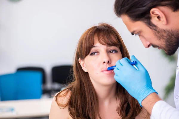 Jovem mulher visita médico dermatologista masculino — Fotografia de Stock