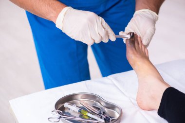 Erkek doktor travmatoloğu ziyaret eden yaralı bir kadın.