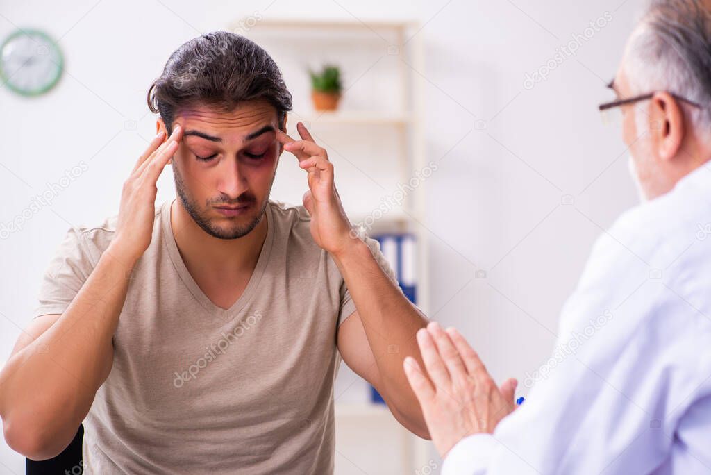 Young face injured man visiting experienced male doctor traumato