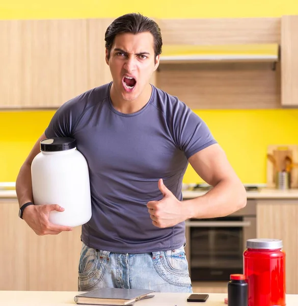 Young man blogging about food supplements — Stock Photo, Image