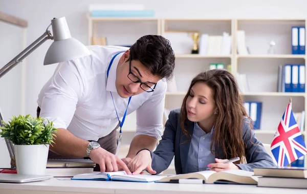 Teacher explaining to student at language training