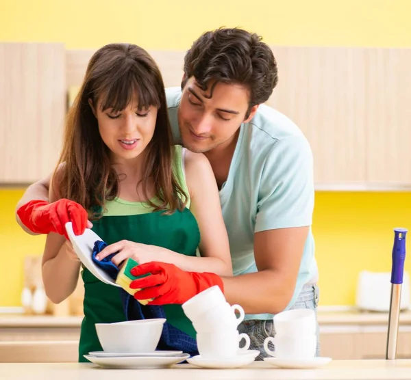 Young couple working at kitchen — Stock Photo, Image