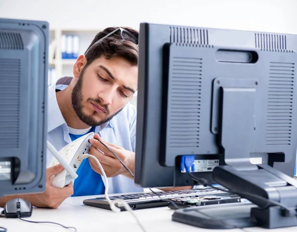 IT technician looking at IT equipment