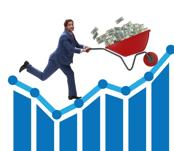 Businessman pushing wheelbarrow full of dollar money — Stock Photo, Image