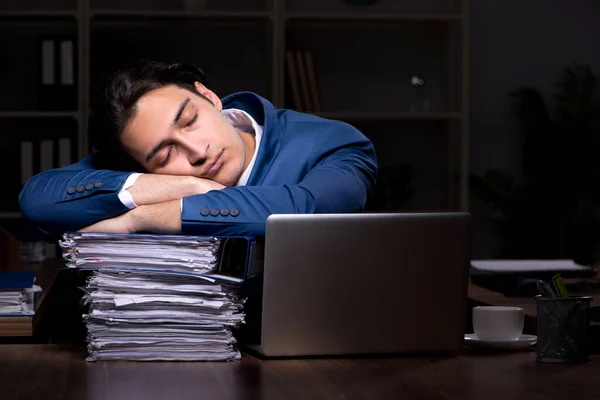 Jeune employé de sexe masculin travaillant la nuit au bureau — Photo