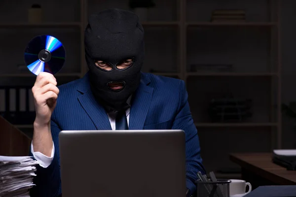 Male employee stealing information in the office night time — Stock Photo, Image