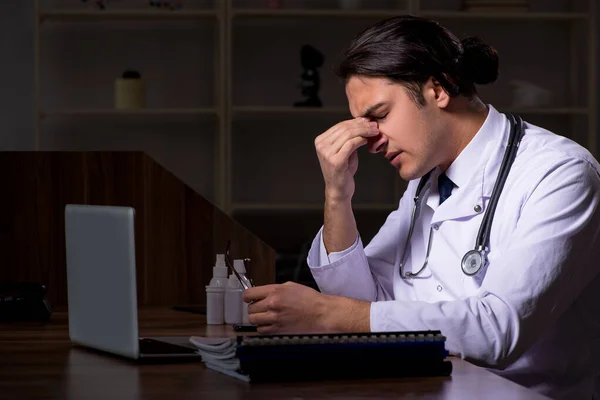 Young male doctor in the hospital at night — Stock Photo, Image