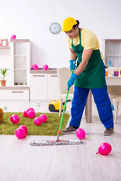 Young male contractor doing housework after party — Stock Photo, Image