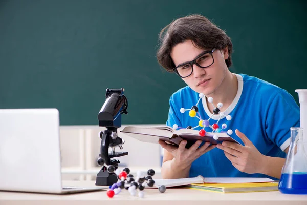 Young male student in the classroom — Stock Photo, Image