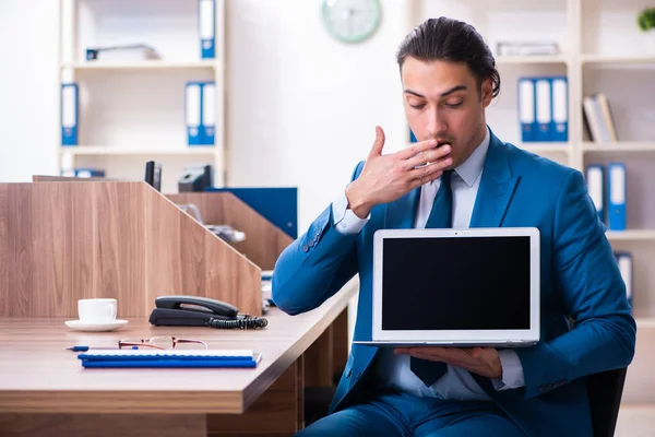 Young handsome businessman sitting in the office — Stock Photo, Image