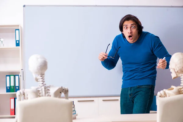 Professor masculino e estudante de esqueleto em sala de aula — Fotografia de Stock