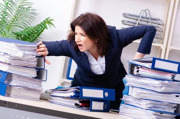 Middle-aged businesswoman unhappy with excessive work — Stock Photo, Image