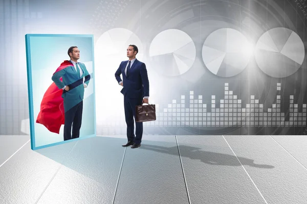 Businessman seeing himself in mirror as superhero