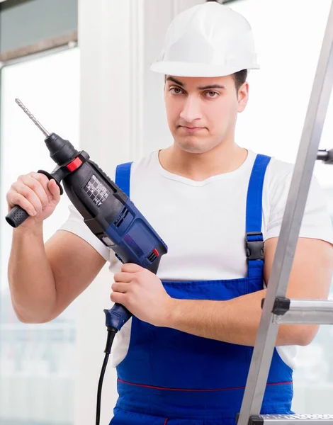 Repairman working with power drill in workshop — Stock Photo, Image