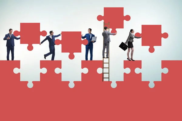 Businessman in teamwork concept with jigsaw puzzle — Stock Photo, Image