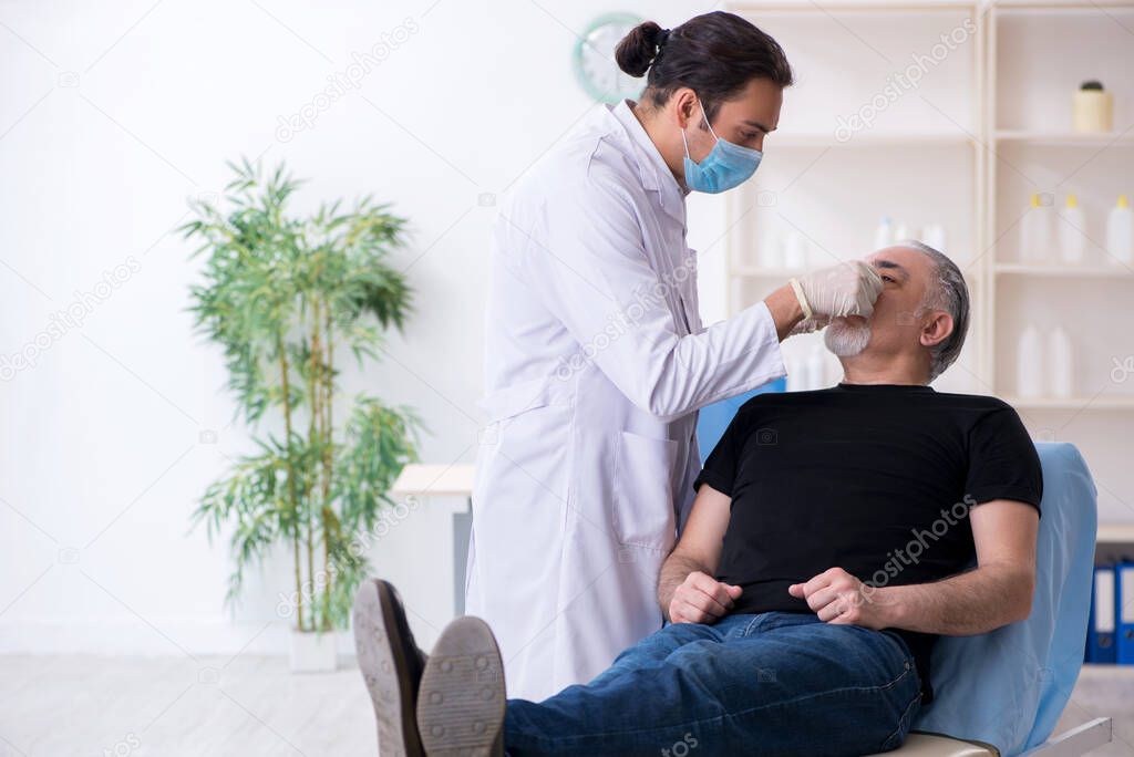 Old man visiting young doctor for plastic surgery