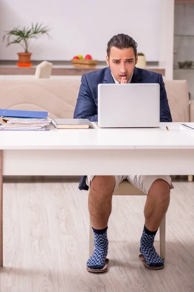 Young male employee working at home during pandemic disease — Stock Photo, Image