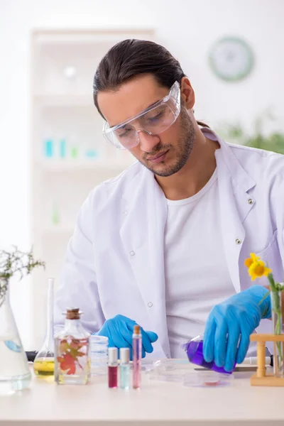 Jonge mannelijke chemicus in parfumsynthese concept — Stockfoto