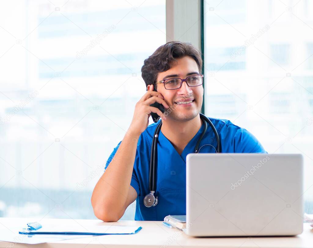 Young handsome doctor working in the hospital